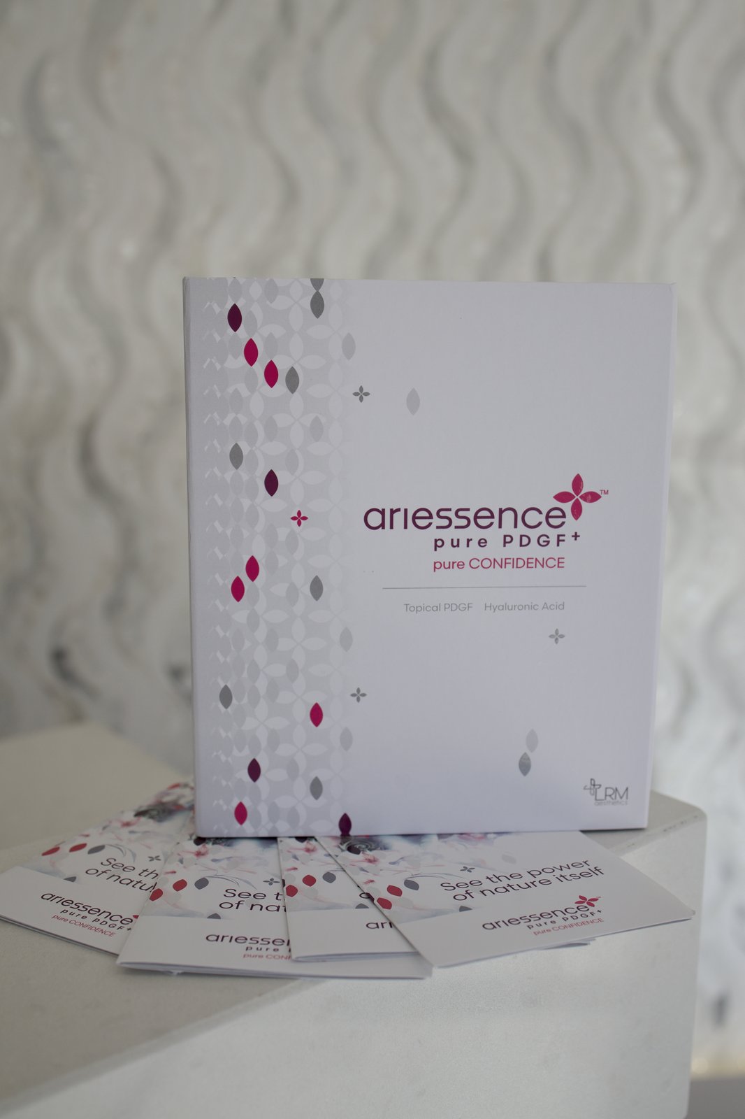 Privé Aesthetics — Ariessence Pure PDGF product box and patient brochures, the recombinant growth-factor protocol carried at the studio