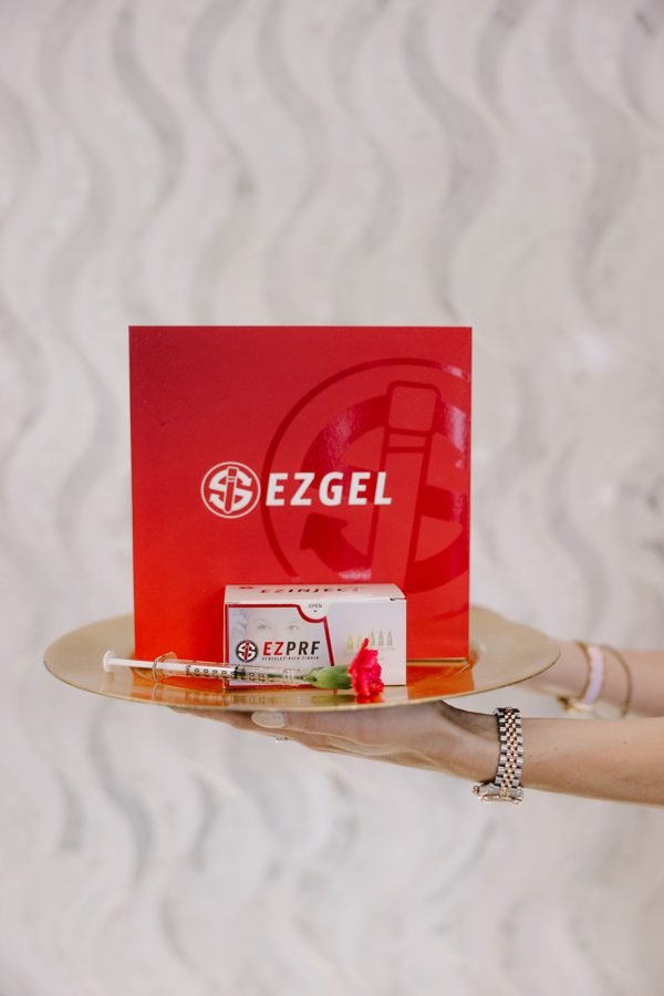 Privé Aesthetics — a client holding the EZGel box at the Hillcrest studio, the autologous plasma-gel biostimulator made from the patient's own blood
