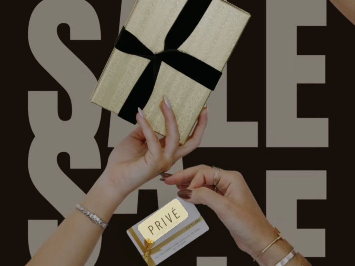 Three hands exchanging a Privé gift box, gift card, and SkinBetter compact against a black ground.
